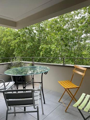 un patio avec une table et des chaises sur un balcon dans l'établissement T3 cosy et lumineux avec terrasse, à Noisy-le-Sec