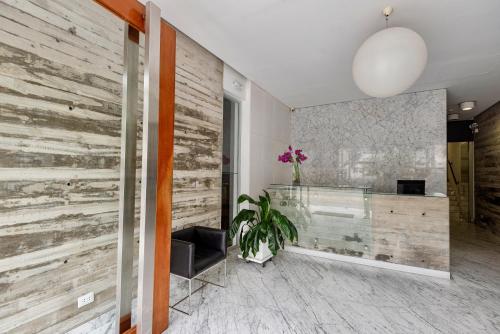 a lobby with a reclaimed wood wall and a desk at ALU Apartments - Miraflores Boardwalk, Wifi 70M in Lima