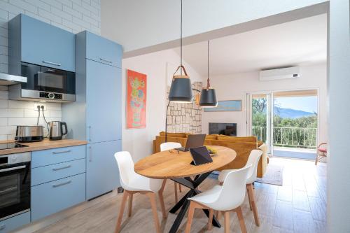 a kitchen and dining room with a wooden table and chairs at Villa Boric by the Sea in Stari Grad