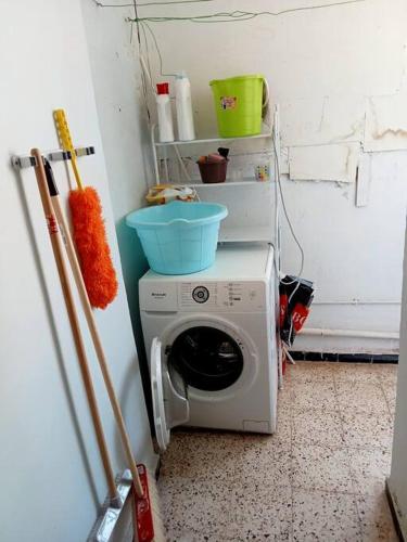 a washing machine with a bowl on top of it at Proche de tout et au calme ! 