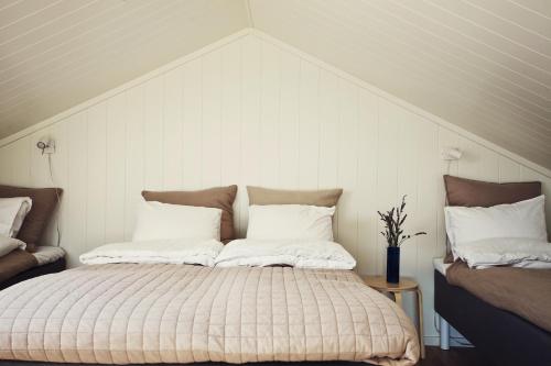 a bed with two pillows on it in a room at Kajkanten Vrångö in Vrångö