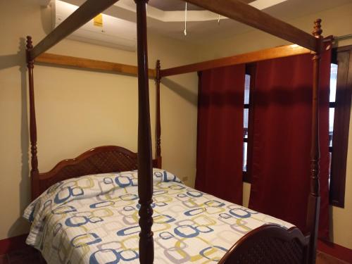 sypialnia z łóżkiem z drewnianą ramą w obiekcie Casa El Caimito w mieście Granada