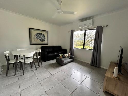 a living room with a table and a couch at Atherton Holiday Park in Atherton