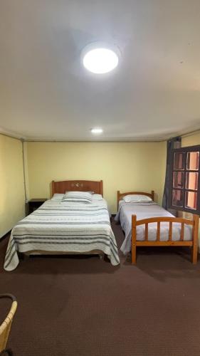 a bedroom with two beds in a room at HOSTAL 469 in La Serena