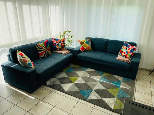 sala de estar con sofá azul y alfombra en Ferienhaus JoNa - 4 Zimmer & 2 Bäder en Oberwesel