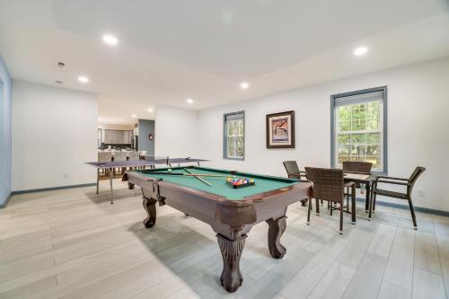 a living room with a pool table and chairs at Deck and Fire Pits Immaculate Poconos Lodge! in Albrightsville