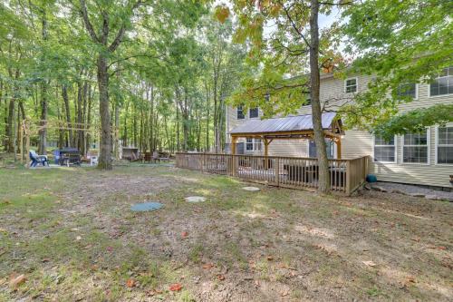 a yard with a fence and a house at Deck and Fire Pits Immaculate Poconos Lodge! in Albrightsville