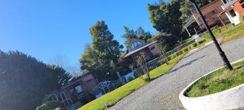 a house on a hill with a winding road at CasaAlpina in Tandil