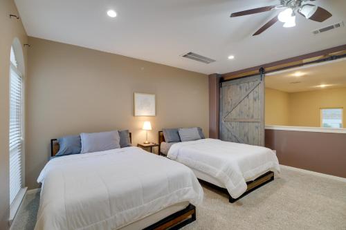 a bedroom with two beds and a ceiling fan at Houston Townhome By George Brown Convention Center in Houston