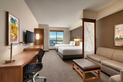 a hotel room with a bed and a desk at Hyatt Place Provo in Provo