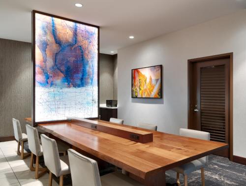 a conference room with a wooden table and chairs at Hyatt Place Provo in Provo