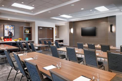a conference room with tables and chairs and a screen at Hyatt Place Provo in Provo