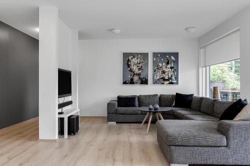 a living room with a couch and a tv at Villa - South Iceland in Laugaras