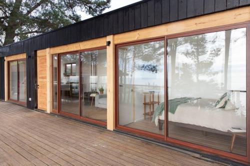 a house with sliding glass doors on a deck at Duerme y despierta en el Mar in Curanipe