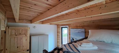 a bedroom with a bed and a wooden ceiling at Lochaber Homesteader Lodge in Antigonish