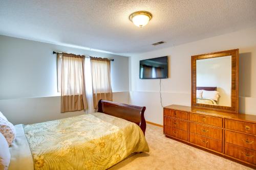 a bedroom with a bed and a mirror and a dresser at Spacious Family Home 11 Mi to Dtwn Minneapolis! in Minneapolis