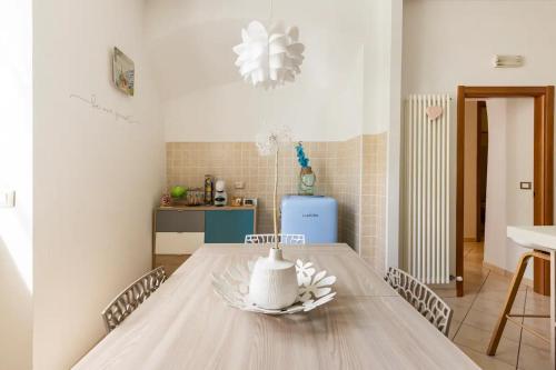 a dining room with a table with a vase on it at Piccola Venezia - Borgo Valsugana in Borgo