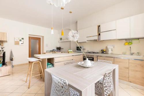 a kitchen with a table and some chairs in it at Piccola Venezia - Borgo Valsugana in Borgo