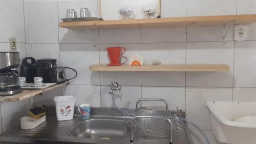 a kitchen with a sink and a counter top with a sink at Lar sossego in Itabuna