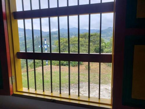 a window with a view of a field of grass at Casa de Campo el mirador in Jericó