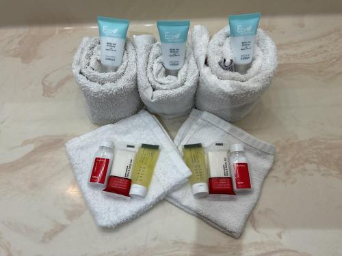 a group of four bottles of moisturizers on towels at Budget Host Inn in Buffalo