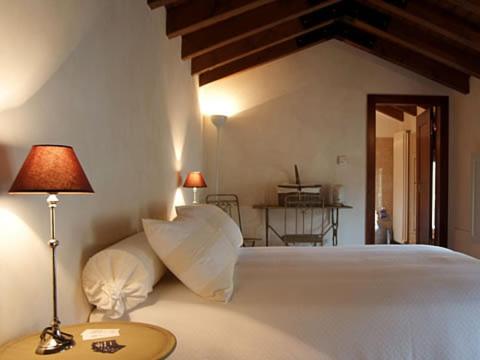 a bedroom with a large white bed with a lamp at B&B Casa del Teatro in Mantova