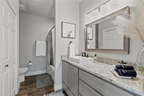 a bathroom with a sink and a mirror at *Brand New Listing* Romantic Getaway Near Main in Fredericksburg