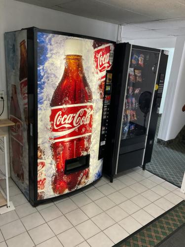 a bottle of cocacola soda in a refrigerator at Budget Host Inn in Buffalo