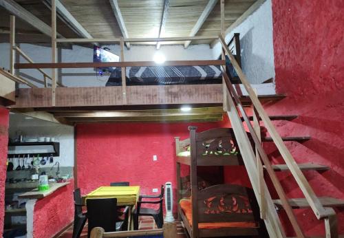 a loft bed in a room with a table and chairs at Estadía SaraIsa in Cali