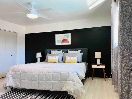a bedroom with a large bed with a black wall at Stylish home in the heart of Tempe w/ private pool in Tempe