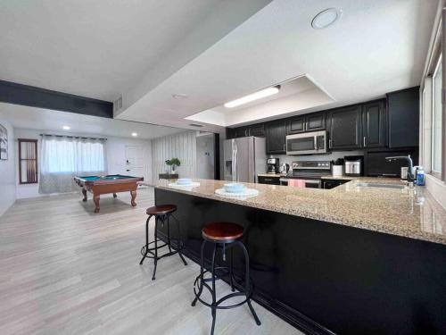a kitchen with a bar and a pool table at Stylish home in the heart of Tempe w/ private pool in Tempe