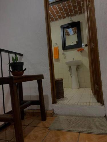 a bathroom with a sink and a toilet in a room at Casa Brisa in Tapalpa