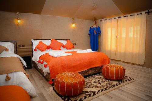 a bedroom with a bed with pumpkins on it at Luxury berber style in Merzouga