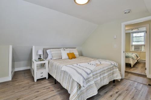 a white bedroom with a bed and a mirror at M20 Rentals Modern Apartment 2bd 1ba Centrally Located Salem, NH in Salem