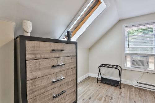 a bedroom with a dresser in a attic at M20 Rentals Modern Apartment 2bd 1ba Centrally Located Salem, NH in Salem