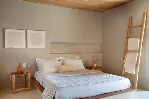 a bedroom with a large bed with a ladder at Kza Patacho in Pôrto de Pedras