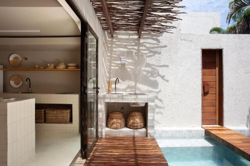 a kitchen with a sink and a swimming pool at Kza Patacho in Pôrto de Pedras