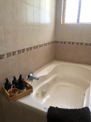 a bath tub with a faucet in a bathroom at Hostal Casa Gaia in San Cristóbal de Las Casas