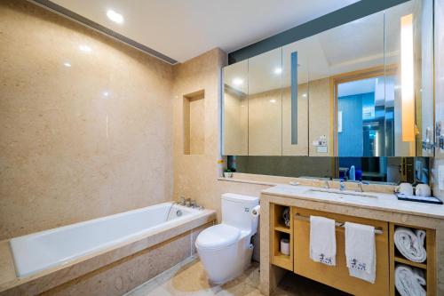 a bathroom with a tub and a toilet and a sink at eStay Residence·Poly World Trade Center Guangzhou in Guangzhou