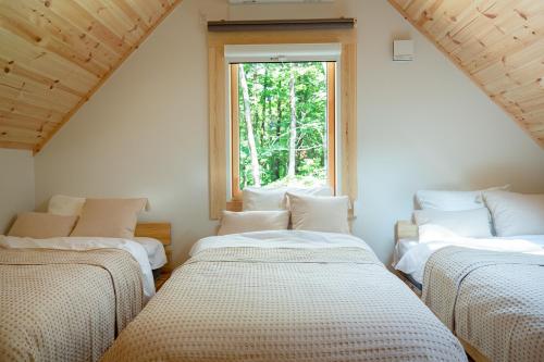 três camas num quarto com uma janela em LEVATA em Nasu