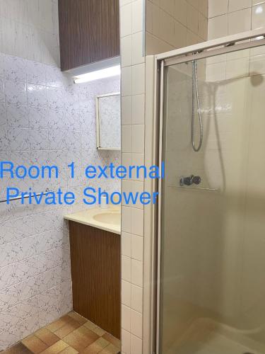 a bathroom with a shower and a sink at Werribee DGH Accommodation in Werribee