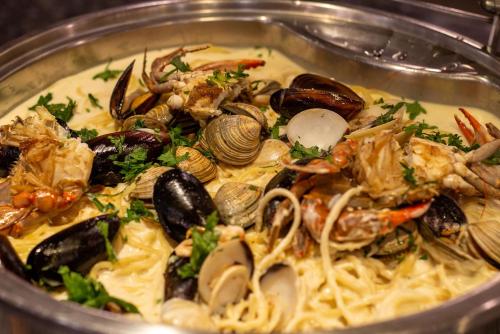 a bowl of food with seafood and noodles at Camino Real Aeropuerto in Mexico City