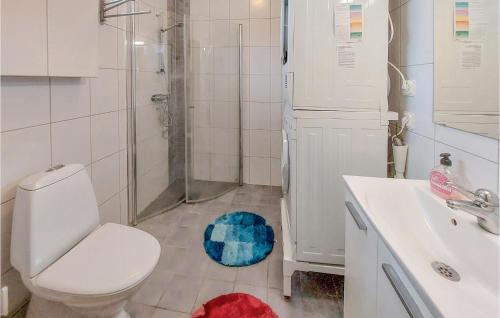a bathroom with a toilet and a shower and a rug at Amazing Home In Halmstad With Wifi in Halmstad