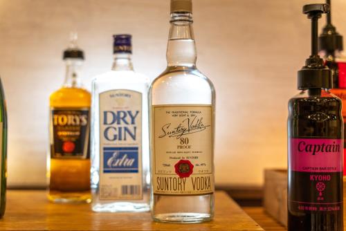 three bottles of alcohol sitting on a wooden table at Super Hotel Tokyo JR Tachikawa Kitaguchi in Tachikawa