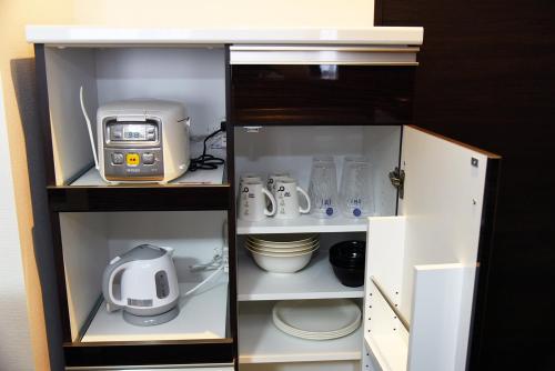 a kitchen cabinet with a appliance in it at サンコート円山ガーデンヒルズ in Ōdōri