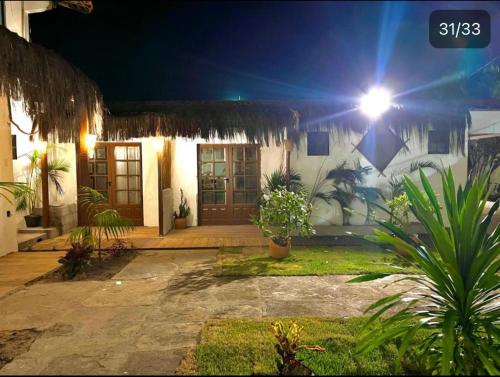 a house with a light on the side of it at night at VILA LITORANEA Hotel in São Luís
