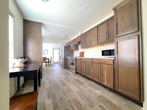 a large kitchen with wooden cabinets and a table at Relax with the Whole Family, 6 minutes to Base in Jacksonville