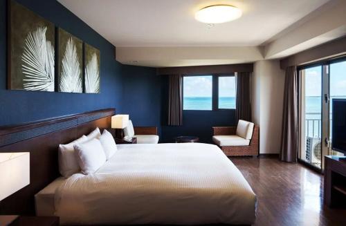 1 dormitorio con 1 cama blanca grande y 1 silla en GRANDVRIORESORT ISHIGAKIJIMA Ocean's Wing & Villa Garden en Isla Ishigaki