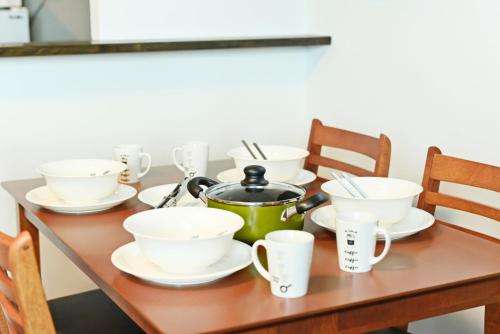 a table with cups and a tea pot on it at Sun Court Hondori Garden Hills in Tsukisappu