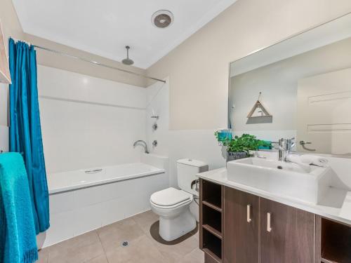 a bathroom with a sink and a toilet and a bath tub at Cypress 39 D in Mulwala